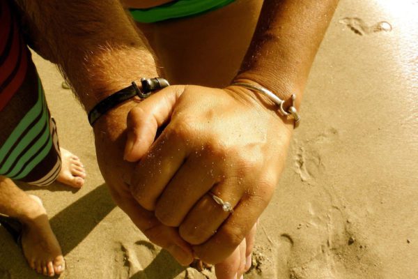 Couple with matching hook bracelets.