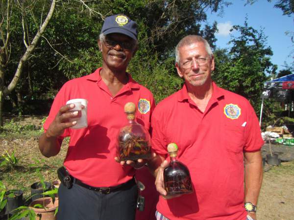 Aubrey Sewer and Doug Benton show off some homemade mama juana at Saturday's event in Coral Bay. 