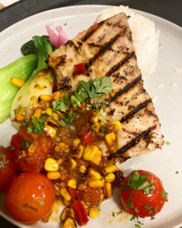 Fresh Grilled Mahi topped with roasted corn & tomato salsa. 